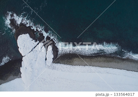Aerial view of the coast and the freezing Barents Sea on the Kola Peninsula in winter, close-up view down Aerial view of the coast and the freezing Barents Sea on the Kola Peninsula in winter, close-up view down 133564017