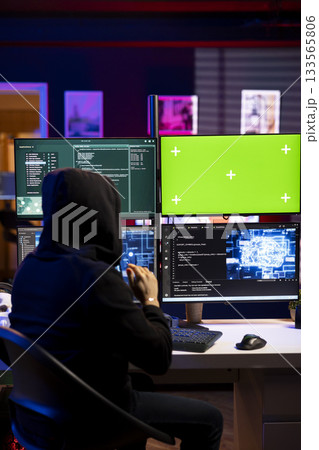 Rogue technician uses AI on green screen PC to develop zero day exploit undetectable by antivirus. Hooded hacker uses mockup computer and artificial intelligence to build script doing data mining Rogue technician uses AI on green screen PC to develop zero day exploit undetectable by antivirus. Hooded hacker uses mockup computer and artificial intelligence to build script doing data mining 133565806