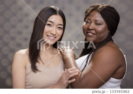 Confident graceful diverse friends posing with radiant healthy skin, advertising natural beauty and body positivity. Modern portrait highlighting self care, natural glow and soft femininity. Confident graceful diverse friends posing with radiant healthy skin, advertising natural beauty and body positivity. Modern portrait highlighting self care, natural glow and soft femininity. 133565862