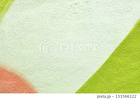 Textured Wall with Abstract Geometric Paint in Green and Orange. 133566122
