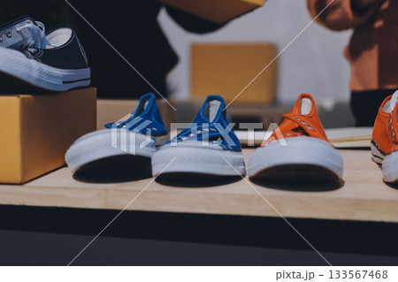Asian woman describe selling clothes on camera live broadcast on social network at home, Online selling clothes on social media. Blogger woman influencer, SME retail store owner. 133567468