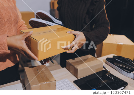 Asian woman describe selling clothes on camera live broadcast on social network at home, Online selling clothes on social media. Blogger woman influencer, SME retail store owner. 133567471