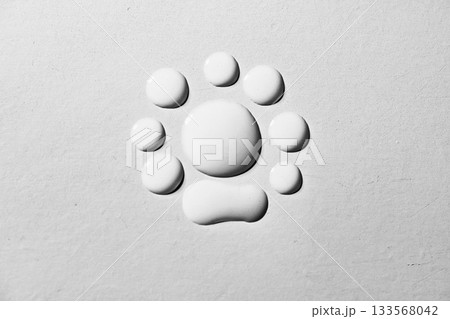 Closeup view of white fluid drops on a textured grey background 133568042
