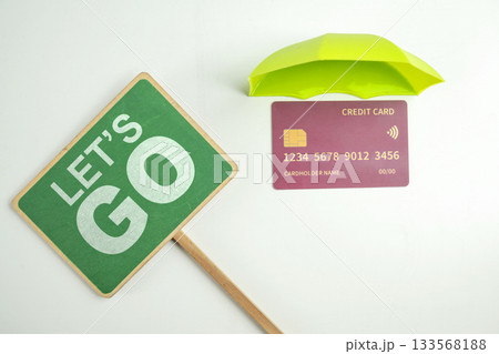 Top view of debit or credit card with green umbrella and green signboard with Let's go text on a white background. Mockup or template. Flat lay. Concept of Security, finance, and business Top view of debit or credit card with green umbrella and green signboard with Let's go text on a white background. Mockup or template. Flat lay. Concept of Security, finance, and business 133568188