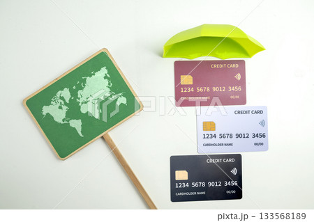 Top view of debit or credit card with green umbrella and green signboard of a worldwide map on a white background. Mockup or template. Flat lay. Concept of Security, finance, and business Top view of debit or credit card with green umbrella and green signboard of a worldwide map on a white background. Mockup or template. Flat lay. Concept of Security, finance, and business 133568189