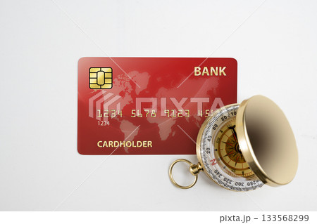 Credit card and antique compass on a white background. Concept of finance and travel Credit card and antique compass on a white background. Concept of finance and travel 133568299