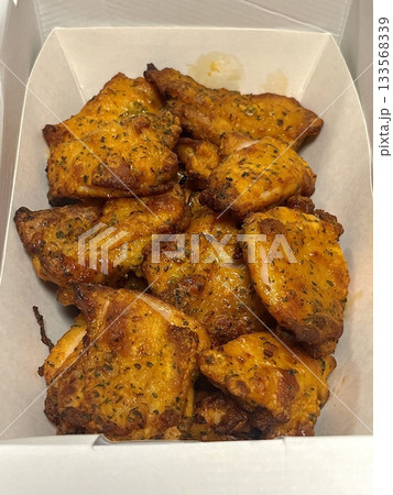 Crispy Korean fried chicken, perfectly glazed with a sweet and spicy sauce. Ideal for food photography and menus, showcasing the irresistible crunch and flavor of this beloved dish. 133568339