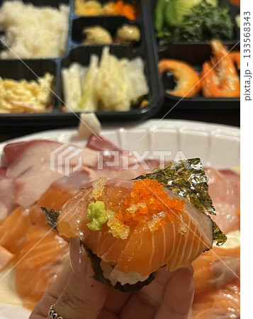 An assortment of fresh sushi, artfully arranged with a variety of toppings and vibrant colors. This traditional Japanese dish combines vinegared rice, seafood, and vegetables for an experience. An assortment of fresh sushi, artfully arranged with a variety of toppings and vibrant colors. This traditional Japanese dish combines vinegared rice, seafood, and vegetables for an experience. 133568343