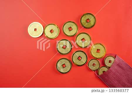 Red envelopes or angpao and golden Chinese coins on a red background. Mockup, template, or copy space. Decoration for the Lunar or Chinese New Year celebration Red envelopes or angpao and golden Chinese coins on a red background. Mockup, template, or copy space. Decoration for the Lunar or Chinese New Year celebration 133568377