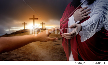 Jesus Christ hand offering a helping hand with a Christian cross on dark dramatic sky background. Concept of Christianity, religious, faith, Jesus, or belief Jesus Christ hand offering a helping hand with a Christian cross on dark dramatic sky background. Concept of Christianity, religious, faith, Jesus, or belief 133568401