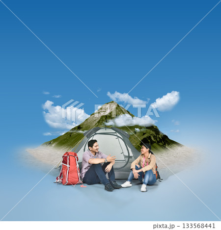 Indonesian southeast asian couple sitting together in front of a camp with a mountain landscape background. Concept of travel Indonesian southeast asian couple sitting together in front of a camp with a mountain landscape background. Concept of travel 133568441
