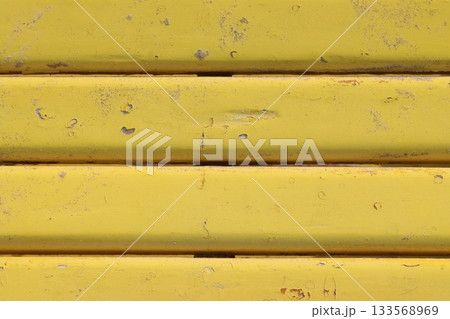 Yellow painted metal surface showing signs of wear and tear Yellow painted metal surface showing signs of wear and tear 133568969