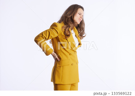 Woman in Pantsuit Suffering From Back Discomfort Woman in Pantsuit Suffering From Back Discomfort 133569122