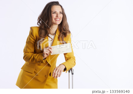 Confident Business Traveler with Ticket and Suitcase 133569140