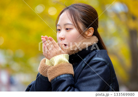 コートを着た笑顔の若い女性 コートを着た笑顔の若い女性 133569980