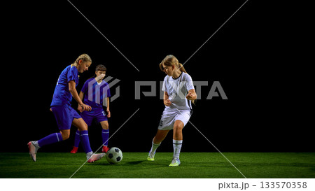 Teenage girls soccer players defending ball under pressure from opponents Teenage girls soccer players defending ball under pressure from opponents 133570358