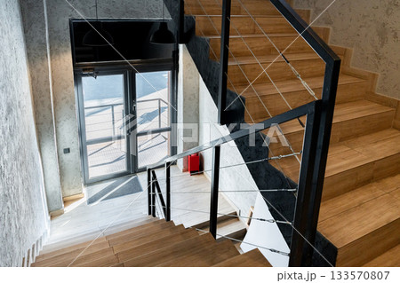 Modern interior staircase in a stylish building with large windows and natural light 133570807