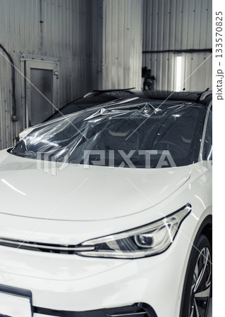 Car preparation in a shop with protective cover while awaiting detailing service Car preparation in a shop with protective cover while awaiting detailing service 133570825