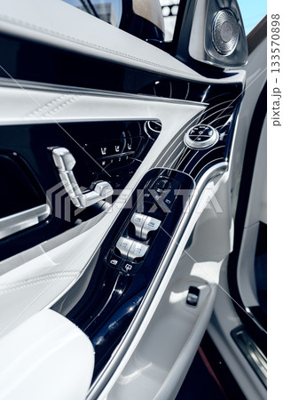 Details of an elegant car interior with modern controls and sleek design features 133570898