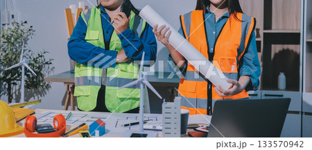 Architects and engineers working collaboratively on construction project Architects and engineers working collaboratively on construction project 133570942