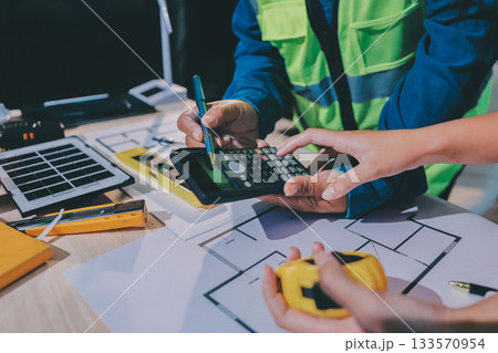 Architects and engineers working collaboratively on construction project 133570954