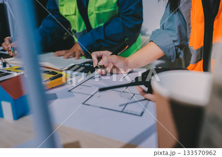 Architects and engineers working collaboratively on construction project Architects and engineers working collaboratively on construction project 133570962