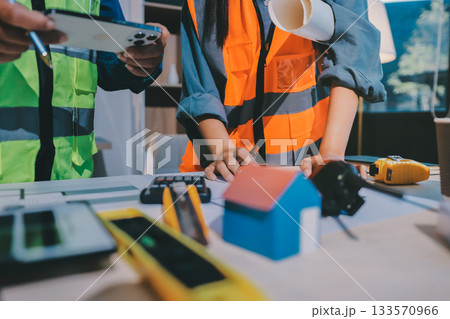 Architects and engineers working collaboratively on construction project Architects and engineers working collaboratively on construction project 133570966