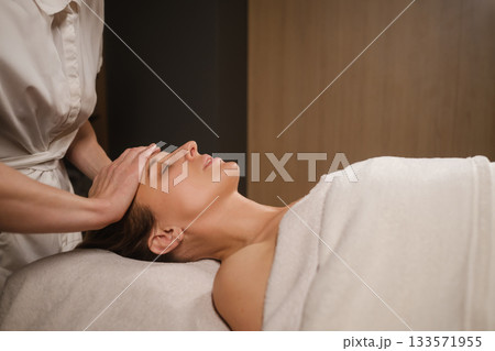 Relaxing massage session in a serene spa environment with a focus on wellness and rejuvenation for the client Relaxing massage session in a serene spa environment with a focus on wellness and rejuvenation for the client 133571955