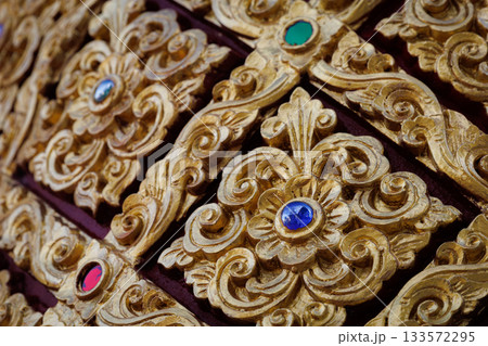 Golden Lanna-style Thai pattern panels decorated with gems for luxurious architecture and decoration. 133572295