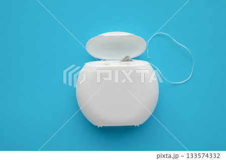 dental floss in case on blue background 133574332