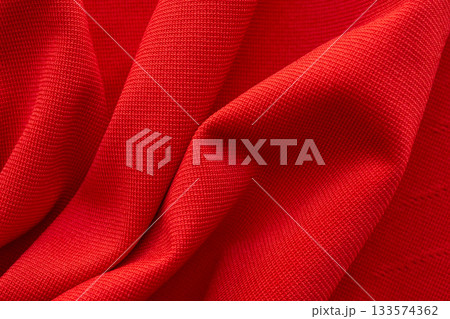 Red sports clothing fabric football shirt jersey texture close up Red sports clothing fabric football shirt jersey texture close up 133574362
