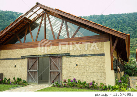 Rustic structure with large windows and wooden details 133576983