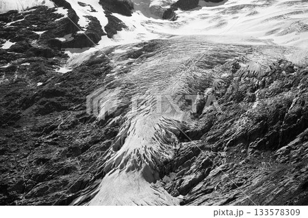 Mountain glacier in Austrian Alps. Schlaten Glacier, German: Schlatenkees, in Venediger Group, Hohe Tauern National Park, East Tyrol, Austria. Black and white image. 133578309