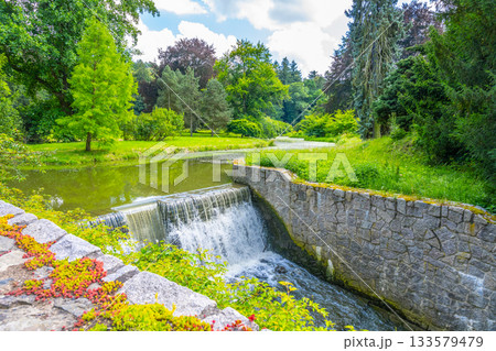 Small double waterfall on the forest stream. Gaden stone sluice in tranquil forest mood. Small double waterfall on the forest stream. Gaden stone sluice in tranquil forest mood. 133579479