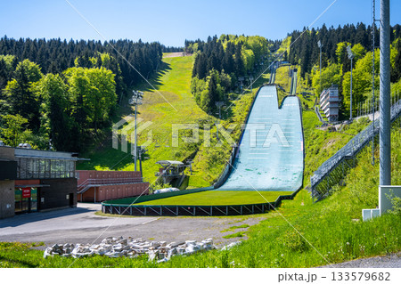 Jested ski jumps in Liberec, Czechia, provide a striking view against lush green hills. The facility is ready for summer training, showcasing its pristine condition and athletic spirit. 133579682