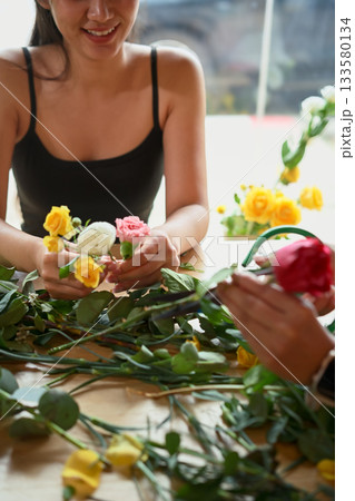 Closeup enjoyment young woman florist arranging plants 133580134