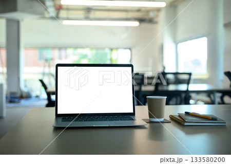 Mockup laptop computer, coffee, book on office table. 133580200