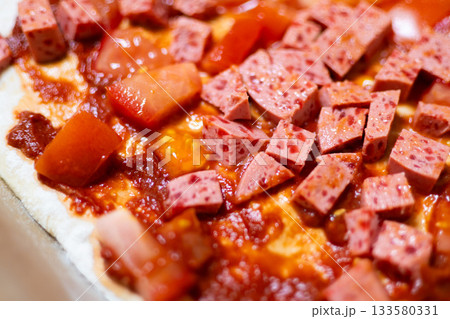 Homemade Pizza with Sausage and Tomato on Baking Tray, Cooking Process 133580331