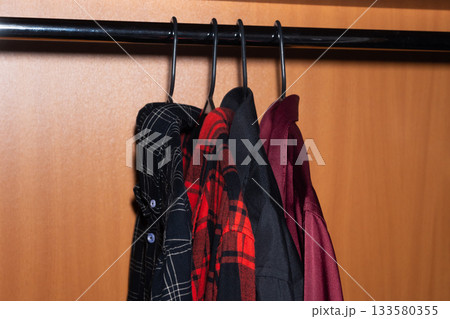 Shirts Hanging in Wardrobe on Hangers 133580355
