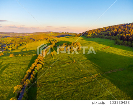Green rural landscape of Northern Bohemia at susnet time. Aerial view from drone. 133580428
