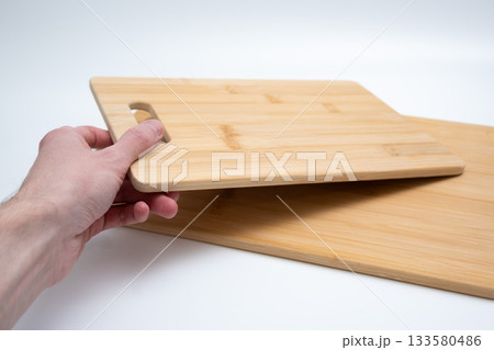 Two Bamboo Cutting Boards with Handles on White 133580486