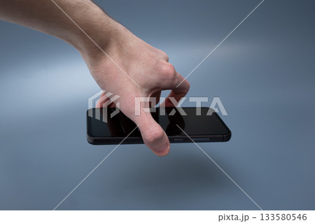 Modern smartphone with triple camera in hand on blue background for advertising 133580546