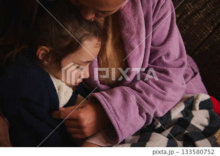 Mother And Child Embrace In Cozy Blanket: Warm Family Moment Of Comfort And Bonding Mother And Child Embrace In Cozy Blanket: Warm Family Moment Of Comfort And Bonding 133580752