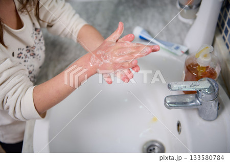 Child Washing Hands With Soap At Sink During Daily Hygiene Routine Child Washing Hands With Soap At Sink During Daily Hygiene Routine 133580784