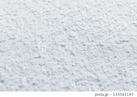 White snow surface shines in sunlight. Close up photography, 133581147