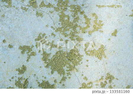 Peeling painted concrete wall, cracks of green blue and beige, peeling paint of the old rough concrete wall, peeling paint texture 133581160