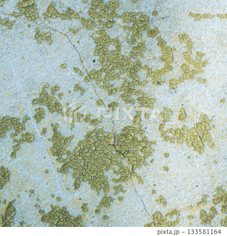 Peeling painted concrete wall, cracks of green blue and beige, peeling paint of the old rough concrete wall, peeling paint texture 133581164