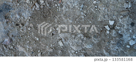 Close-up of a gray-black lava texture on the ground. Porous, cracked, and stony, perfect as a stock texture or photo background. Impression of molten rock. 133581168