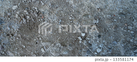 Close-up of a gray-black lava texture on the ground. Porous, cracked, and stony, perfect as a stock texture or photo background. Impression of molten rock. Close-up of a gray-black lava texture on the ground. Porous, cracked, and stony, perfect as a stock texture or photo background. Impression of molten rock. 133581174