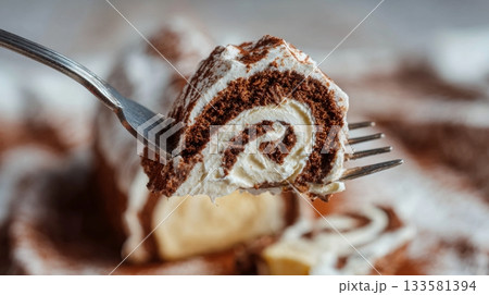 Macro photo of a fork lifting a slice of buche de noel, showcasing creamy swirls and rich chocolate textures, perfect for holiday dessert inspiration 133581394